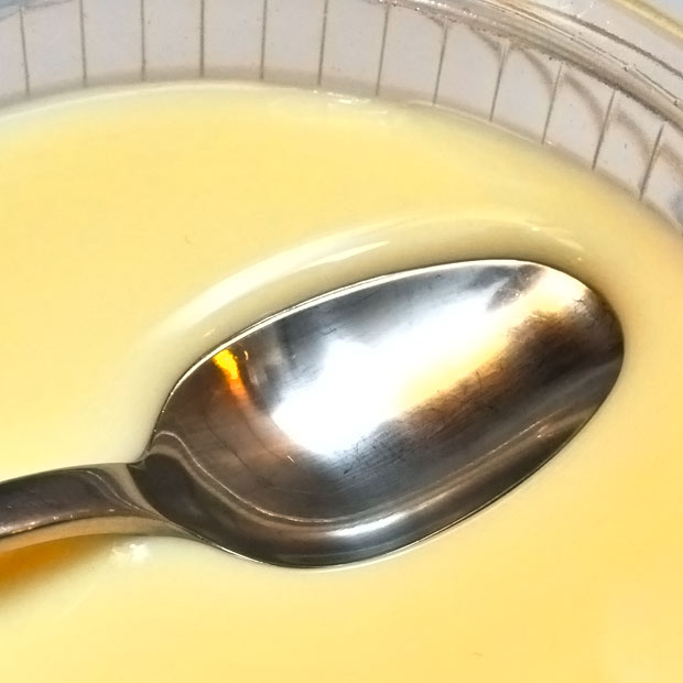 ginger-milk-curd-floating-spoon-closeup